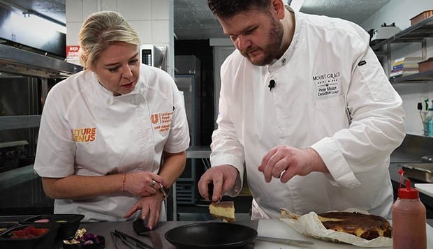 Chef Pieter Malan and a fellow chef preparing a dish together in the kitchen.