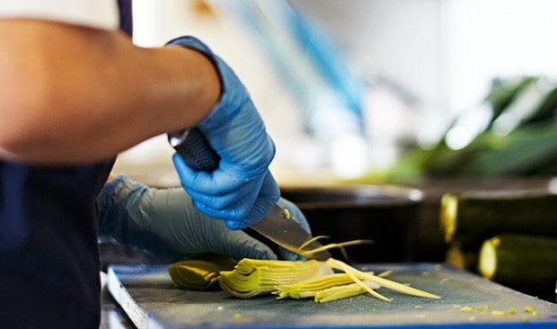 Chef prepping with gloves on.