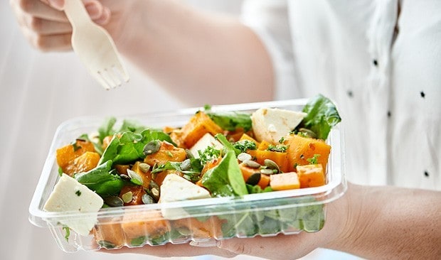 Healthy salad in takeaway container.