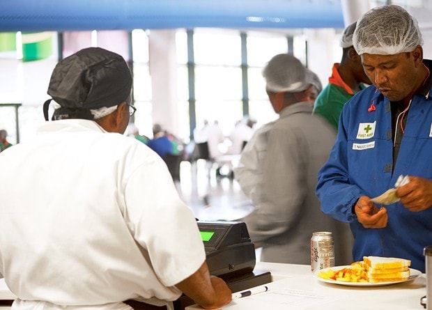 Factory workers getting a meal. 