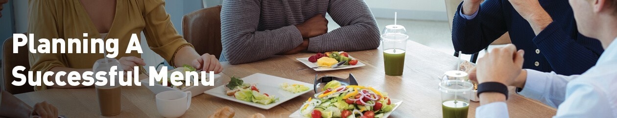 Office workers eating around a table. 