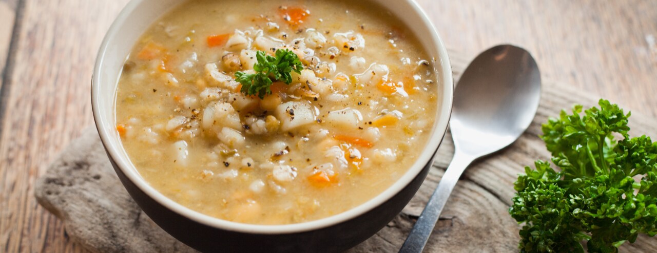Bowl of cooked grains with spoon. 