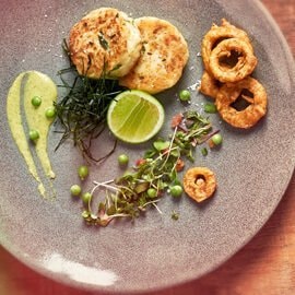 Fish Cakes with Onion Bhajas, a Micro Herb Salad  and Pea Cream