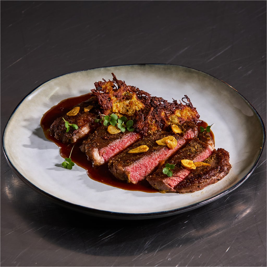 Rib-Eye With Pepper Crust, Crispy Garlic & Potato Hashbrown Crisp